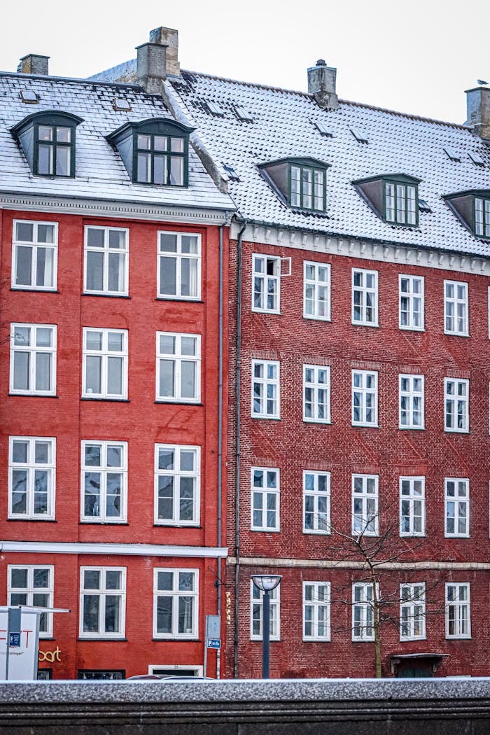 home-services-004 Snow-covered red buildings in Copenhagens urban landscape.